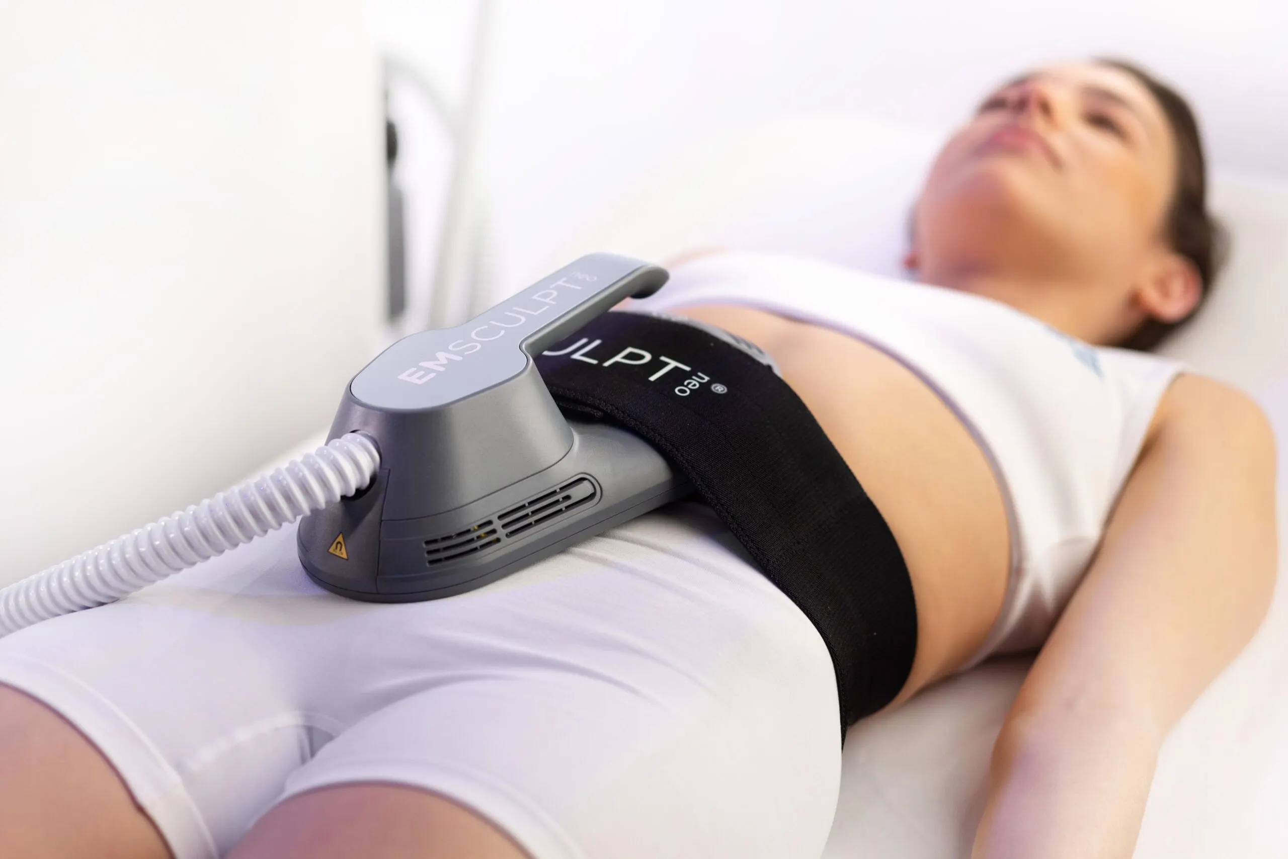 Physician-led Emsculpt Neo body contouring treatment at Bodiatrics in Suwanee GA, applicator on a patient's abdomen