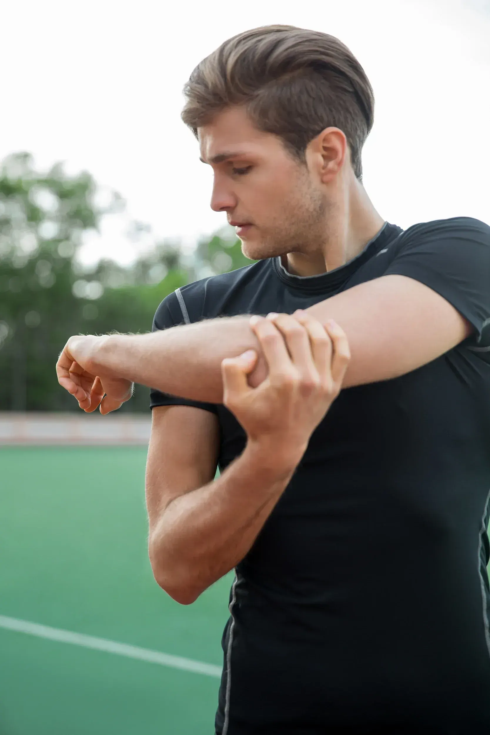 Adult noticing knee and hip discomfort while standing, a sign of weight-related joint pain