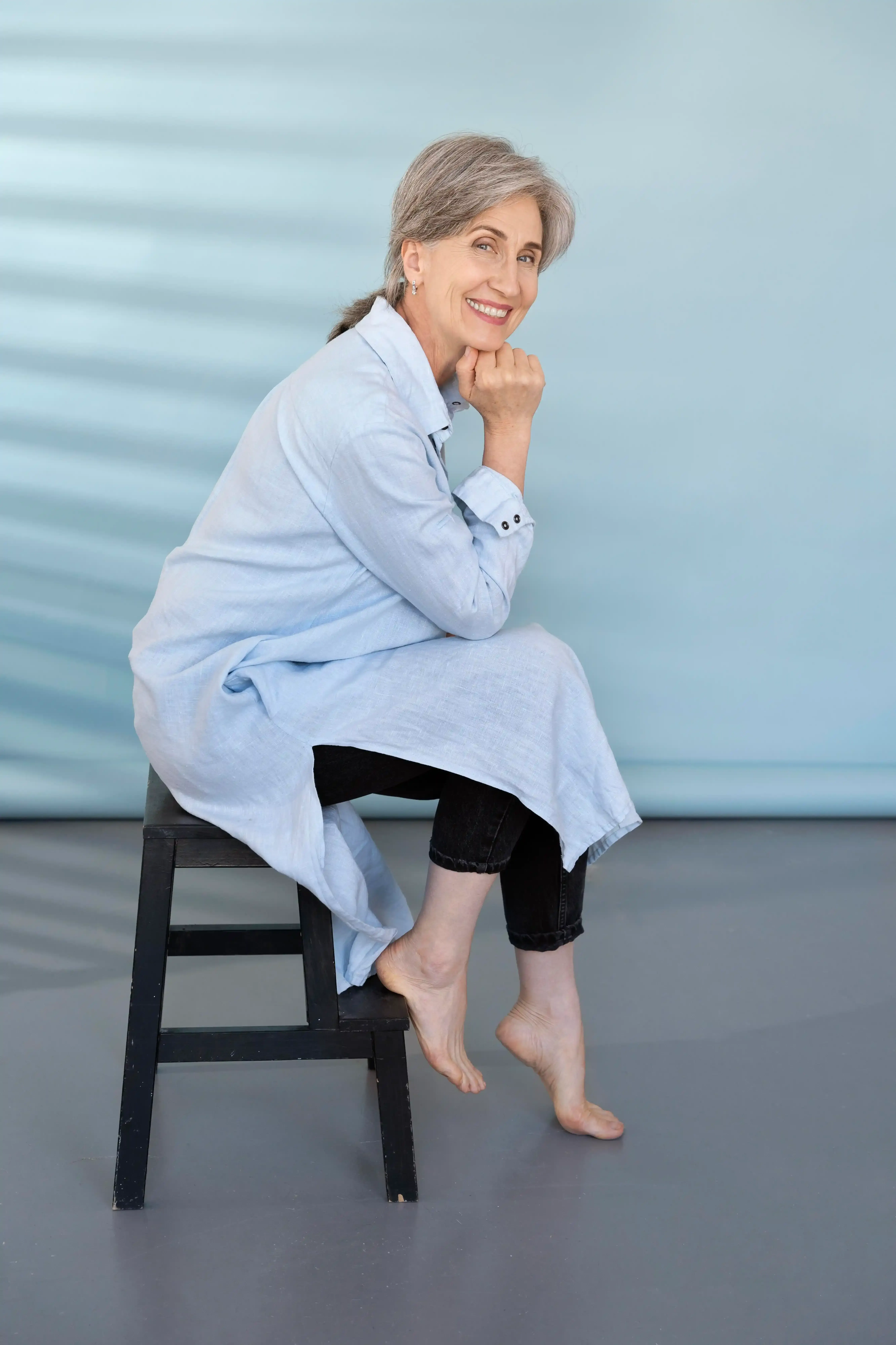 Confident patient standing after a sclerotherapy consultation at a Suwanee, GA vein center