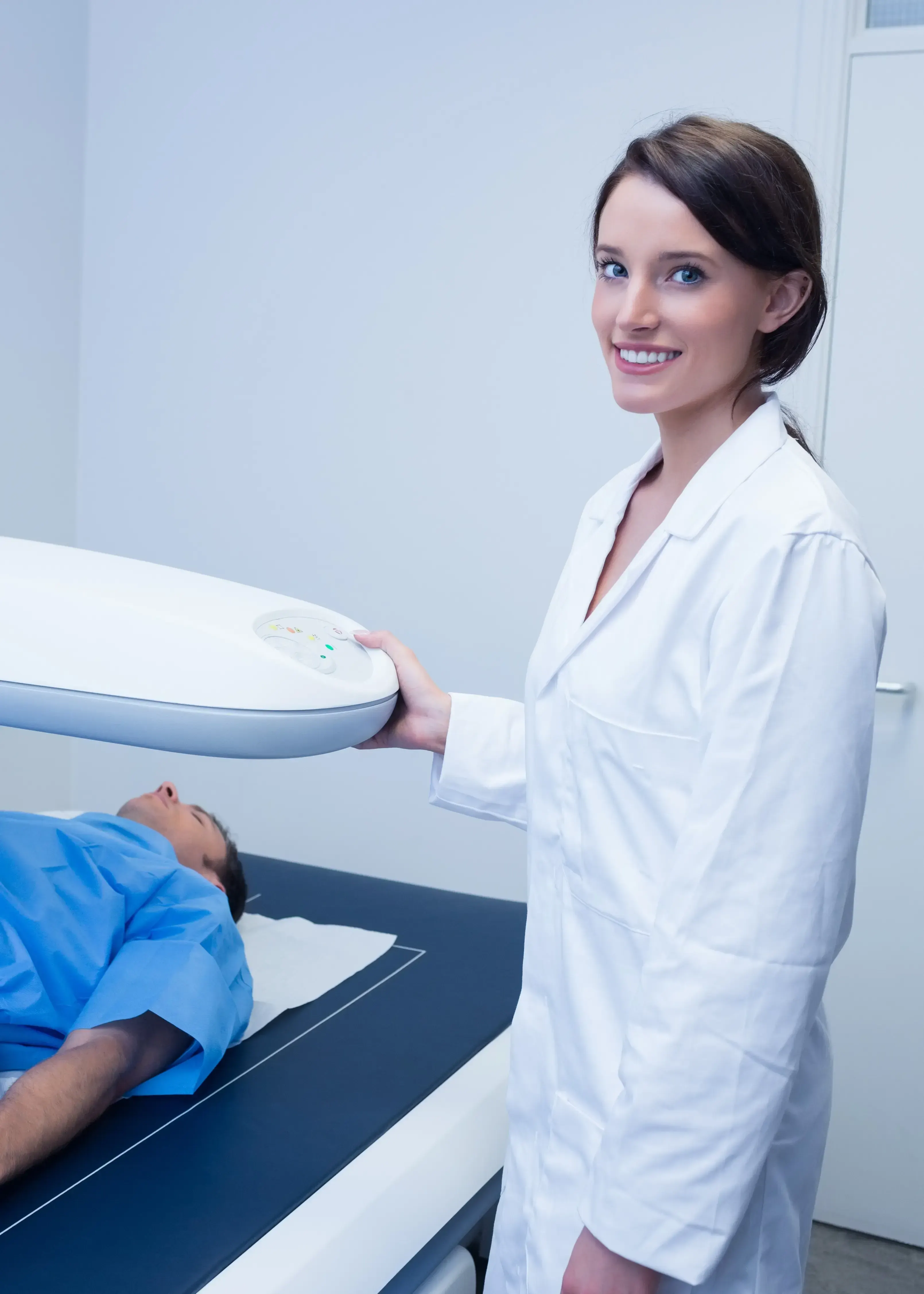 Confident health-conscious adult patient prepared for a DEXA body composition scan at Bodiatrics
