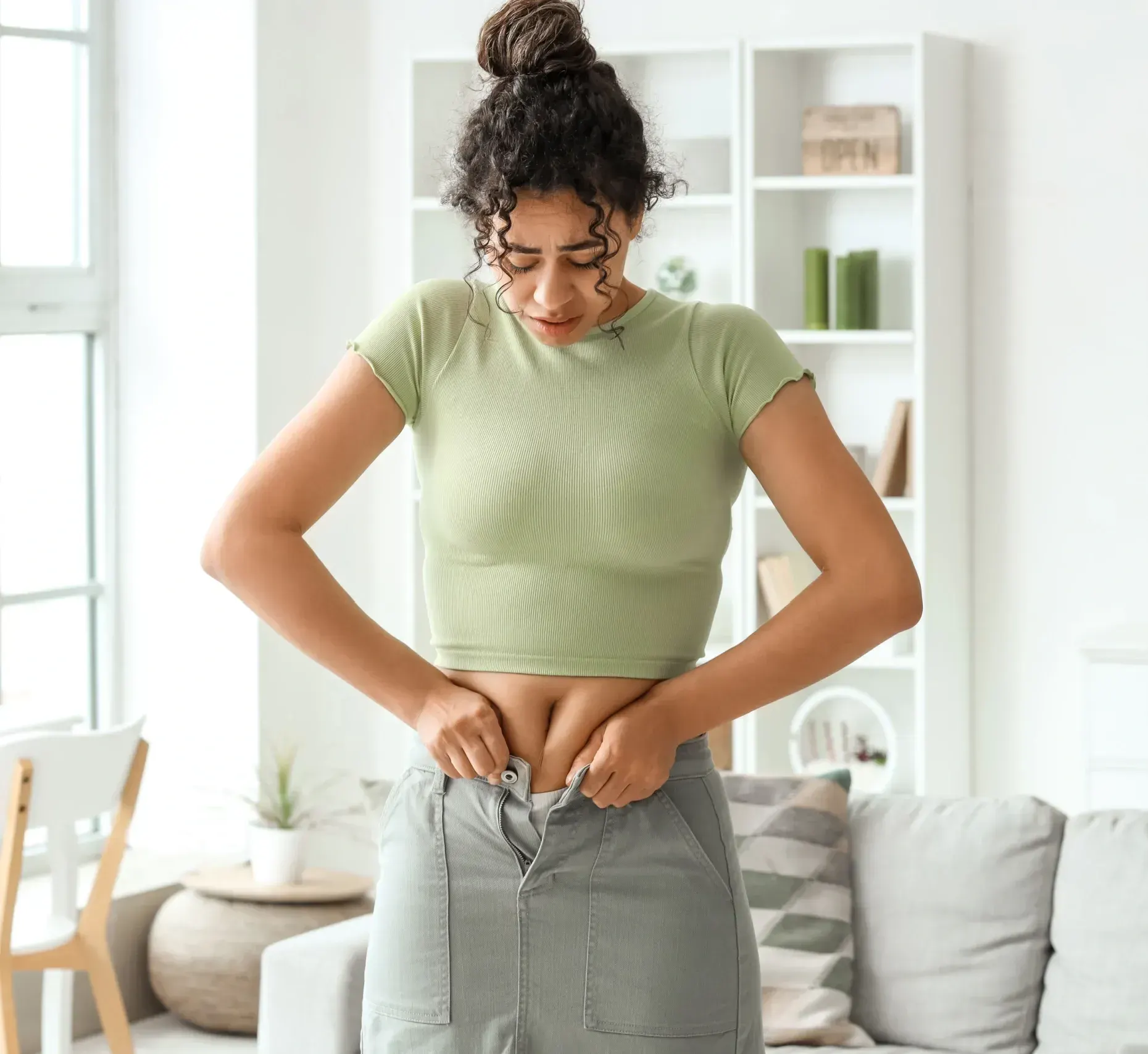 Illustration of a stretched gastric pouch and hormonal drivers behind bariatric weight regain